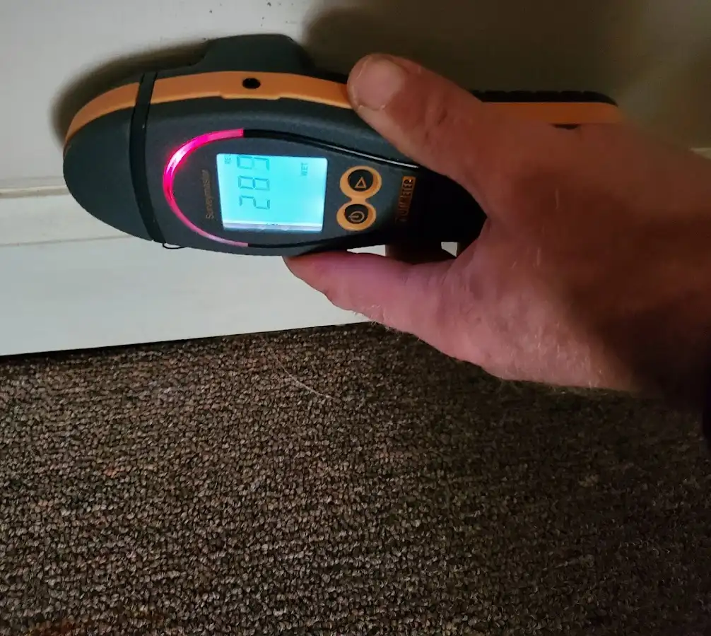 Moisture detection at baseboard during Storm Damage Restoration in Warren